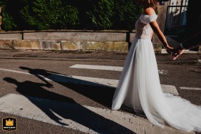 In Verdun, France, just after the couple's photo shoot, as they return to the venue for the cocktail hour, a detail shot captures the intricate shadows cast on the roadway, adding a touch of artistry to the urban scene.